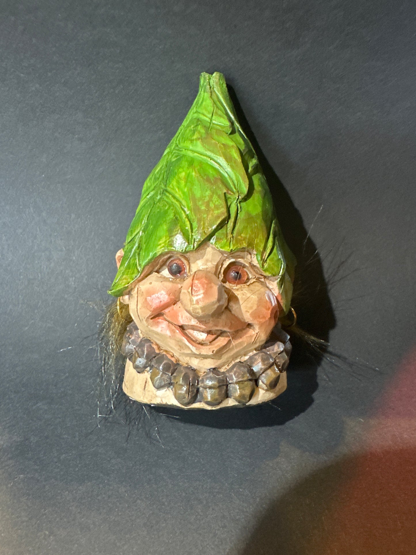 Elf with green hat and a necklace