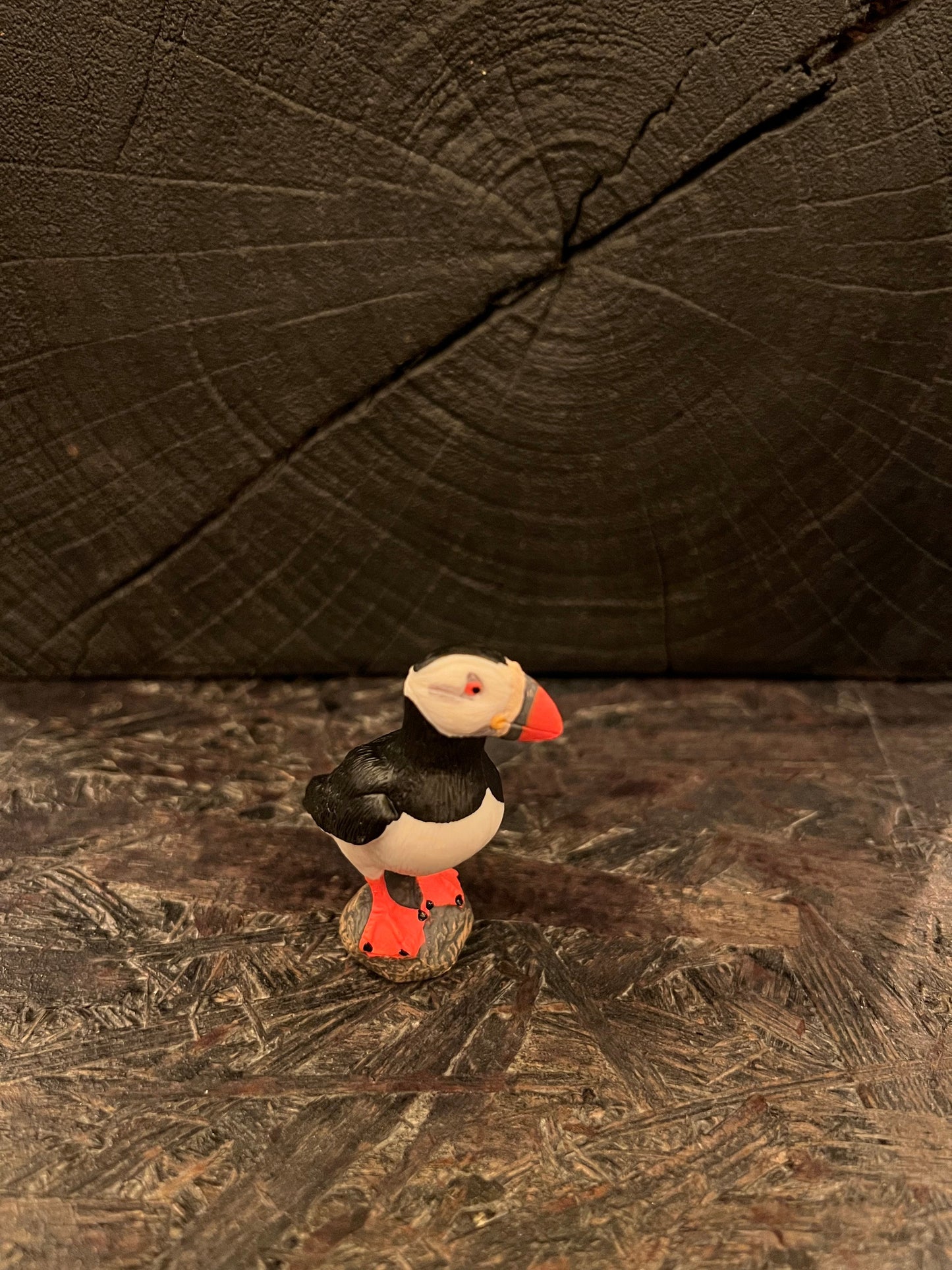 Puffin figurine standing on stone